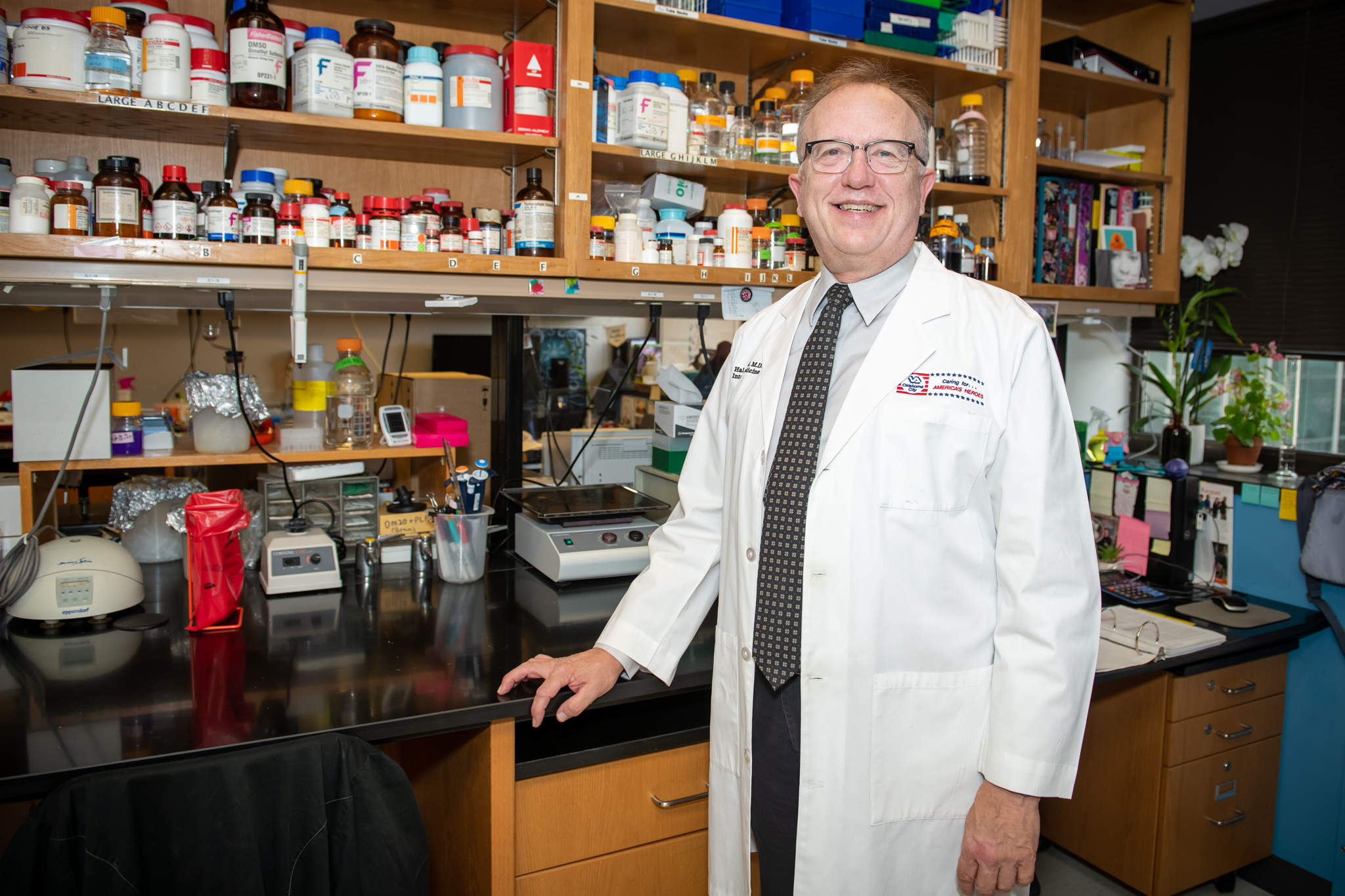 Dr. R. Hal Scofield standing in his lab