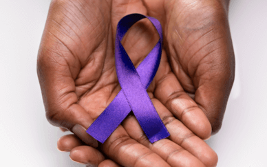 Pair of hands holding an Autoimmune Disease Awareness ribbon 